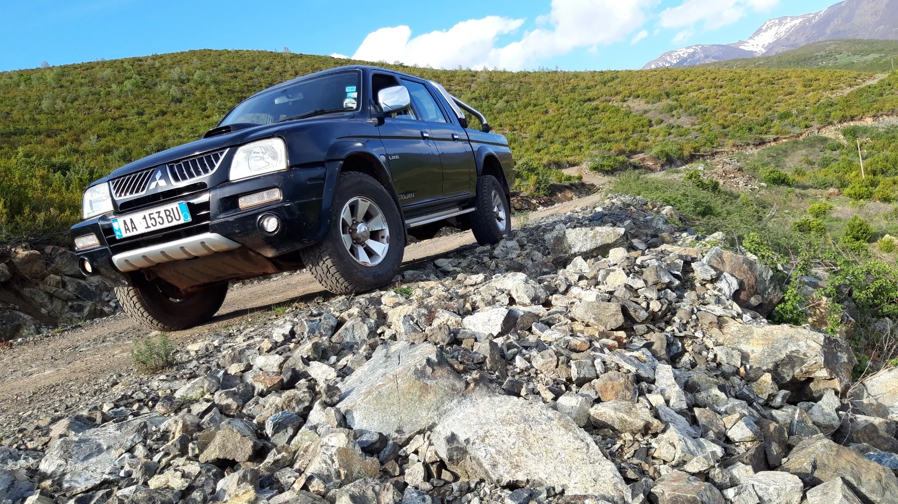 Black Mitsubishi L200 on a rocky Shebenik mountain track