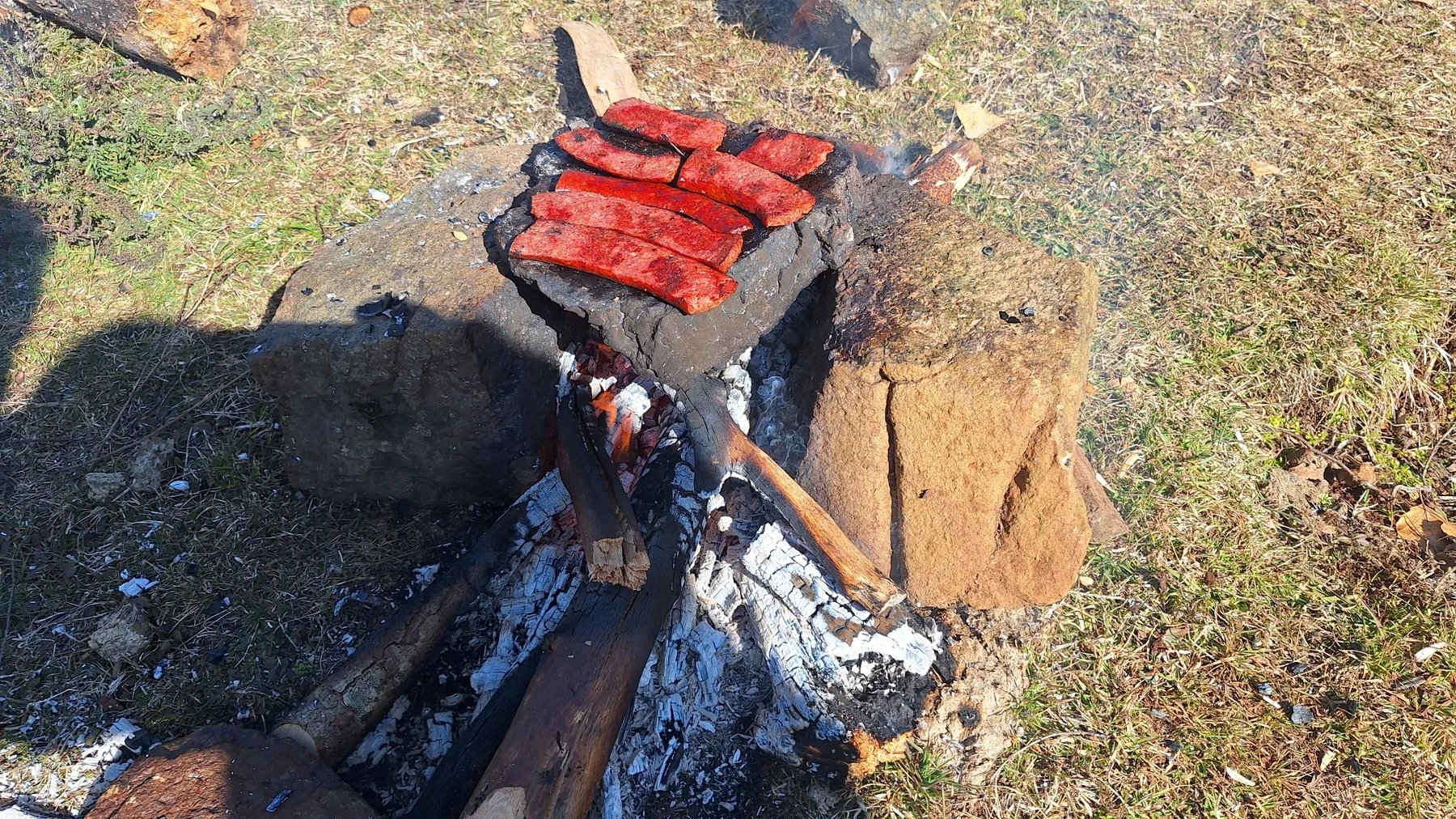 Simple outdoor food being prepared over a mountain fire